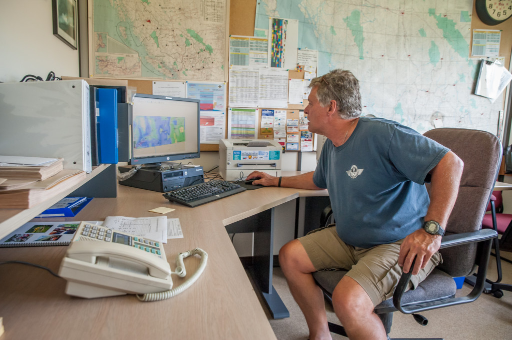Ben MoerKoert, Air Attack officer, can see all wildfire activity and air attack crews in the province on a computer at the Penticton Airtanker Base. Before computers, communication was by radio. (Richard McGuire photo)